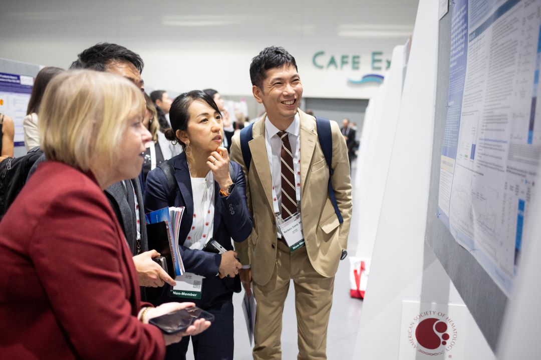 Annual Meeting attendees view and discuss an abstract.
