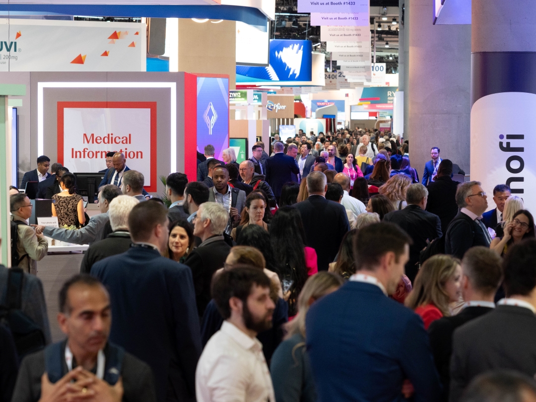 Attendees navigate a full and colorful exhibit hall.