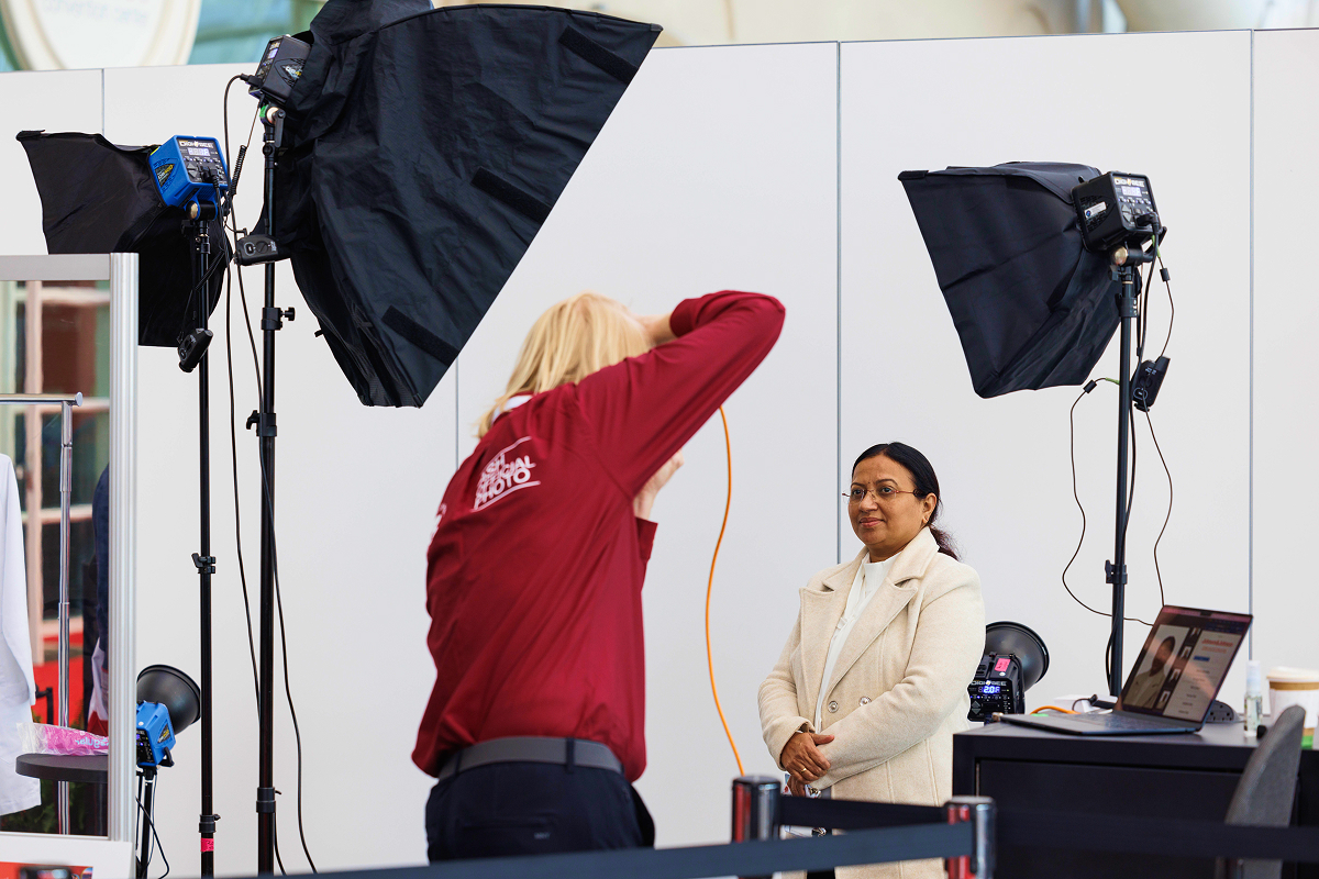 At Headshot Alley, a photographer is taking a photo of a person during the ASH annual meeting.