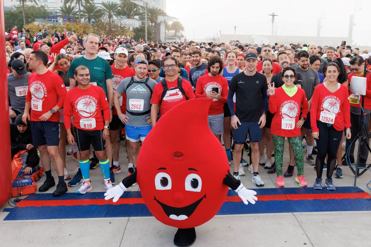 Run/Walk participants wait at the starting line with Red, ASH's mascot