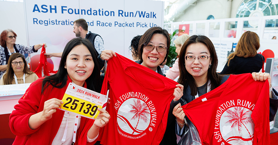 A three young female holding ASH Foundation t-shirts 