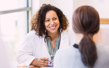 A photo of a Clinician attending to a patient during clinic visit